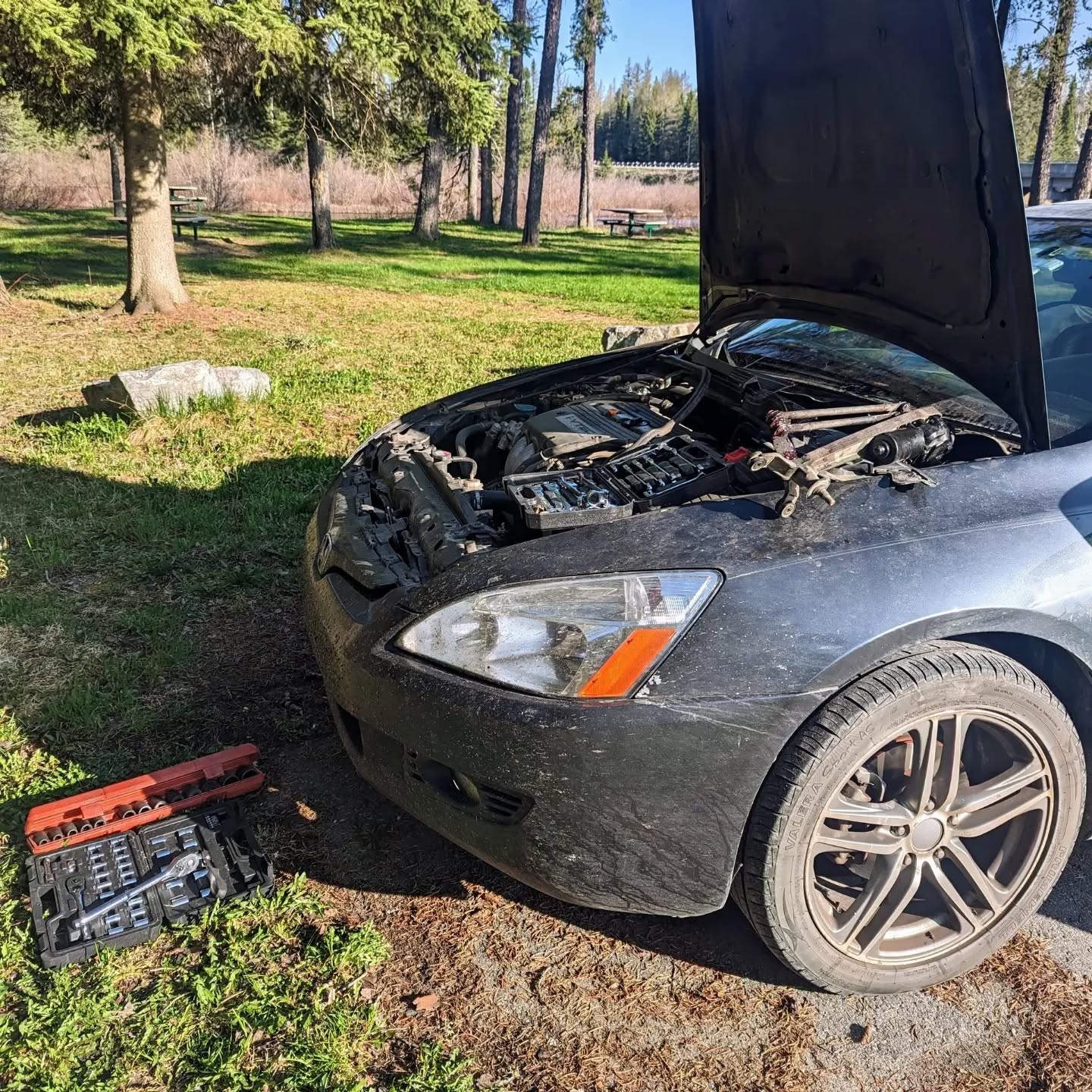 The car with its hood open and tools ready at Pukaskwa